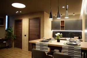a kitchen with a island with chairs and a table at Rebecca House suites in Catania