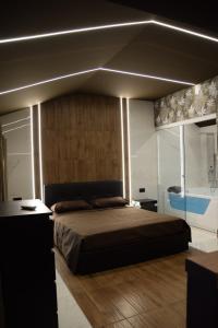 a bedroom with a large bed with lights on it at Rebecca House suites in Catania