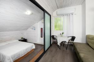 a bedroom with a bed and a table and chairs at Galilaeaen Loft in Chorazim +23 photos