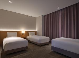 Postel nebo postele na pokoji v ubytování Sotetsu Hotels The Splaisir Seoul Dongdaemun