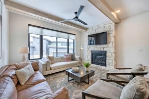a living room with a couch and a fireplace at Mountain-View Townhome Near Powder Mountain! in Huntsville