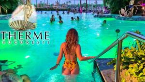 a girl in a bikini in a swimming pool at a theme park at Doxa Airport Otopeni in Otopeni