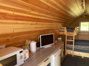 a computer on a desk in a log cabin at Marina Bay Pods in Aberdeen