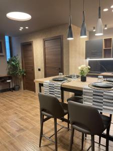 a kitchen with a table and chairs in a room at Rebecca House suites in Catania