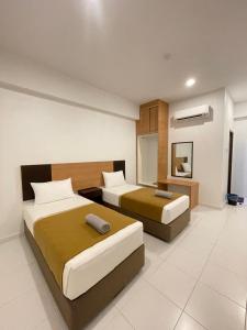 a hotel room with two beds and a mirror at DZ Hotel Salor in Kota Bharu +21 photos
