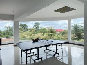 a ping pong table in a room with a large window at DZ Hotel Salor in Kota Bharu