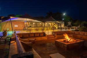 een patio met een vuurplaats 's nachts bij Mantis Akagera Game Lodge in Akagera