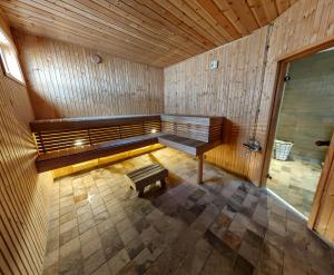 an empty sauna with a bench and a table at Aurora Cone in Kiruna