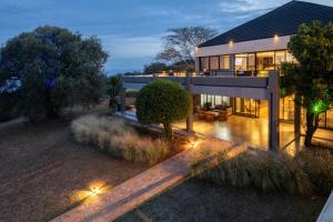 a large house with lights in front of it at Mantis Akagera Game Lodge in Akagera