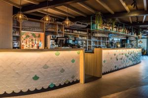 a restaurant with a bar with a lot of drinks at Suites Boulevard 17 in Vlissingen