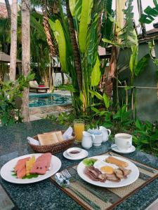 a breakfast table with plates of food and drinks at Natural Relax Villa in Siem Reap