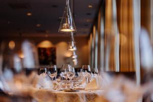 um grupo de copos de vinho sobre uma mesa em Hotel Benther Berg em Ronnenberg