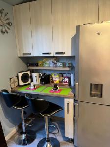 a kitchen with a counter and a refrigerator at Jolie studio in Rueil-Malmaison