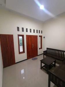 a living room with a bench and a table at Anugrah homestay in Cirebon