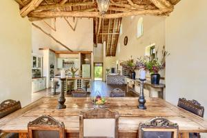 a large kitchen and dining room with a large wooden table at Adara Palmiet Valley Luxurious Boutique Farm Hotel in Paarl