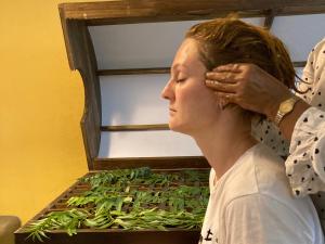 a woman standing in front of a box of greens at Handagedara Resort & Spa in Mirissa