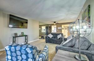 a living room with couches and a table with a lamp at Lake of the Ozarks Vacation Rental with Grill! in Lake Ozark