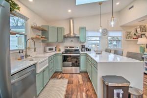 a kitchen with green cabinets and white counter tops at Sunny Front Royal Vacation Rental with Hot Tub! in Front Royal