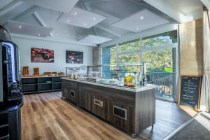 a large kitchen with a counter with a counter top at Les Jardins de l'Anjou in La Pommeraye