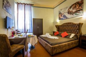 a bedroom with a large bed and a table with a tableablish at Tuscany Love DELLE TELE-FIRENZE in Florence