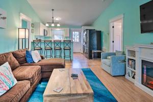 a living room with a couch and a coffee table at Oak Island Vacation Rental Less Than 1 Mi to Beach! in Oak Island