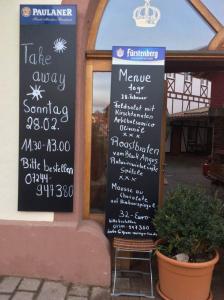 ein Schild an der Seite eines Restaurants mit einer Speisekarte in der Unterkunft Gasthaus zur Krone in Weingarten (Karlsruhe)