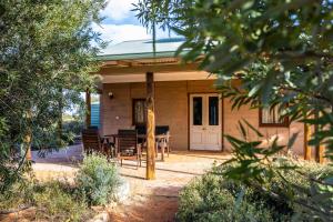 a house with a table and chairs in front of it at Wooleen Station in Wooleen