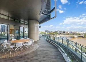 a balcony with a table and chairs on a building at Stylish Stay for Couples in CBD by Stylish Stays in Brisbane