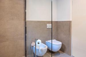 a bathroom with a toilet and a glass shower stall at Falsers Mountain Lodge in Cornedo all'Isarco +24 photos