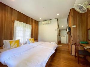 a bedroom with two beds and a desk at Mangrove bungalow & restaurant in Ko Kood