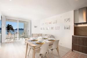 a kitchen and dining room with a table and chairs at Apartment Sivella in Pollença +14 photos