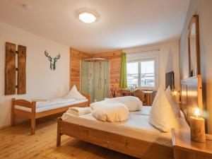 a bedroom with two beds and a mirror at Hostel - Ron`s Guesthouse in Oberstdorf