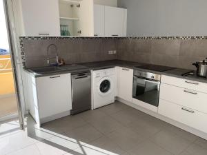 a kitchen with a washing machine and a sink at La Ciotat vue mer emplacement exceptionnel avec parking in La Ciotat
