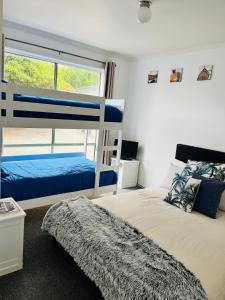 a bedroom with two bunk beds and a window at THE PHILLY in Cowes