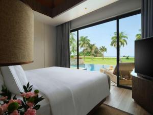 Voodi või voodid majutusasutuse Pullman Lombok Merujani Mandalika Beach Resort toas