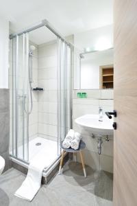 a bathroom with a shower and a sink at Pension Ebnerwirt in Eben im Pongau