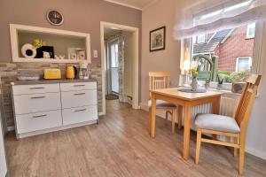 a kitchen with a table and a dining room at Kiek rin bi Kati - Ferienwohnung 1 in Langeoog