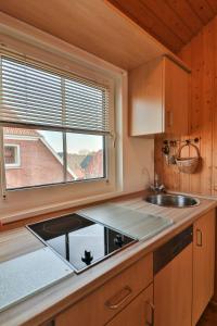 a kitchen with a sink and a window at Killewipps OG in Langeoog
