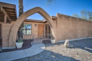 a home with an archway in front of a house at Eastside Home with Pool Near Hiking! in Tucson