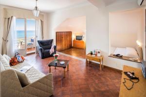 a living room with a couch and a table at Hotel Golfo e Palme in Diano Marina