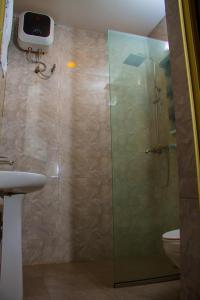 a bathroom with a glass shower with a toilet at Go2Hotel45 in Lagos