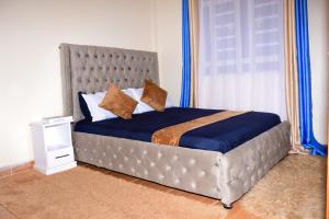 Кровать или кровати в номере The Hideout Thika Town