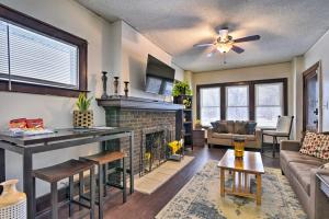 a living room with a fireplace and a couch at Awesome Detroit Apartment Less Than 3 Mi to Midtown! in Detroit