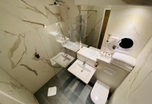 a bathroom with a toilet and a sink at Hotel Marc Aurel - Newly refurbished in Vienna