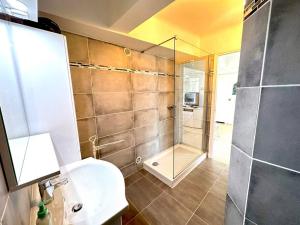 a bathroom with a glass shower and a sink at Viva Riviera Large 1 Bedroom with Sunny Terrace in Cannes