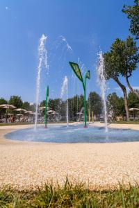 a water park with two fountains in the middle at Club del Sole Rimini Family Resort in Rimini