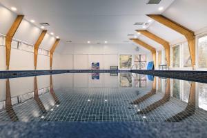 an empty swimming pool with its floors and windows at Bos Chalet Durbuy in Durbuy