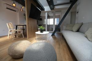 a living room with a couch and a table at Apartments Emona FREE Parking-sauna-gym in Ljubljana