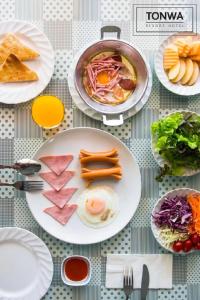 a table with plates of food on it at Tonwa Resort Hotel in Khon Kaen
