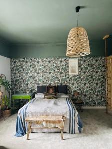 a bedroom with a bed and a pendant light at Room in exclusive villa in sentral Oslo in Oslo